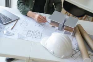 Architecture Man drawing on architectural Creative project business architecture building construction Industrial engineering Achievement Planning Design on laptop.