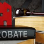 Probate law book and model of house on it.