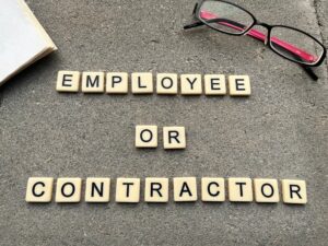 Image of tiles spelling employee or contractor
